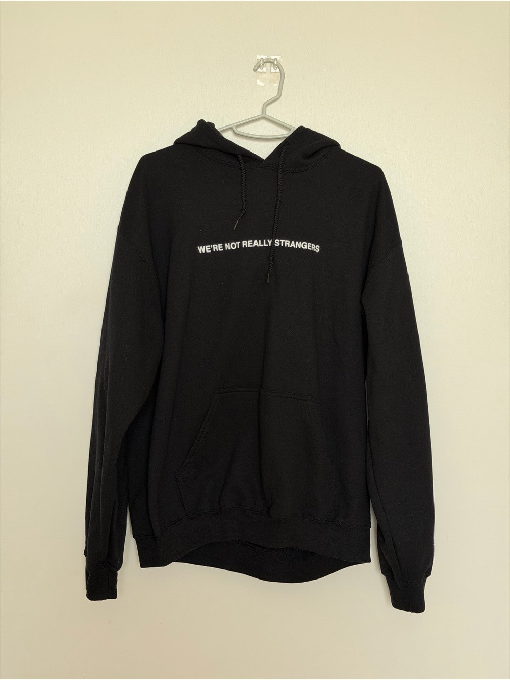 Black We’re not really strangers Pullover Hoodie with White Text